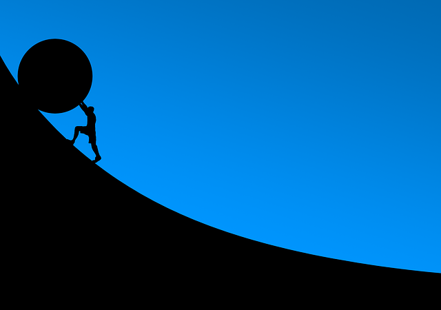 man pushing a stone up